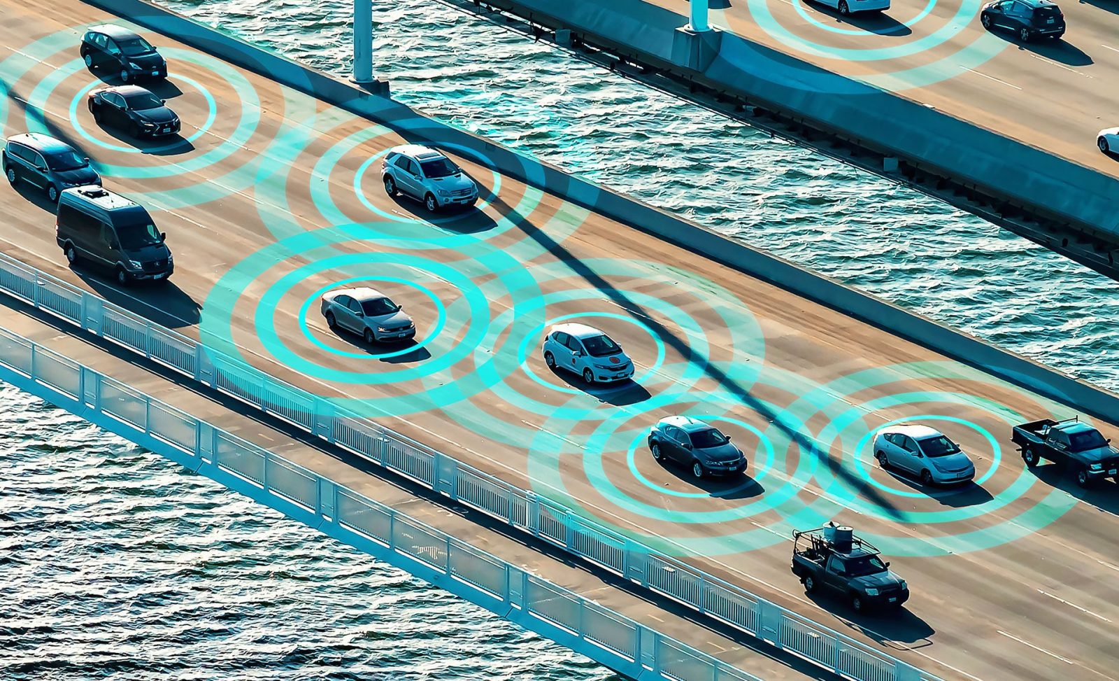 Bridge over sea with cars in motion.