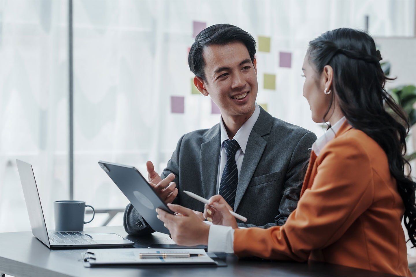 Two people in an office discuss the different types of vehicle fleet leases