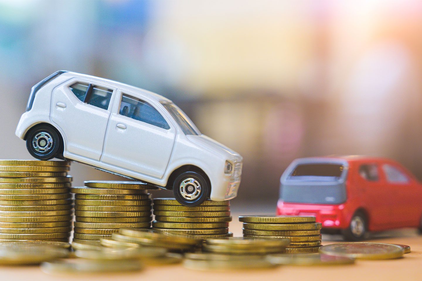 Miniature Vehicles on stacks of coins for fleet vehicle savings