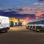 Commercial fleet vans in a parking lot at dusk