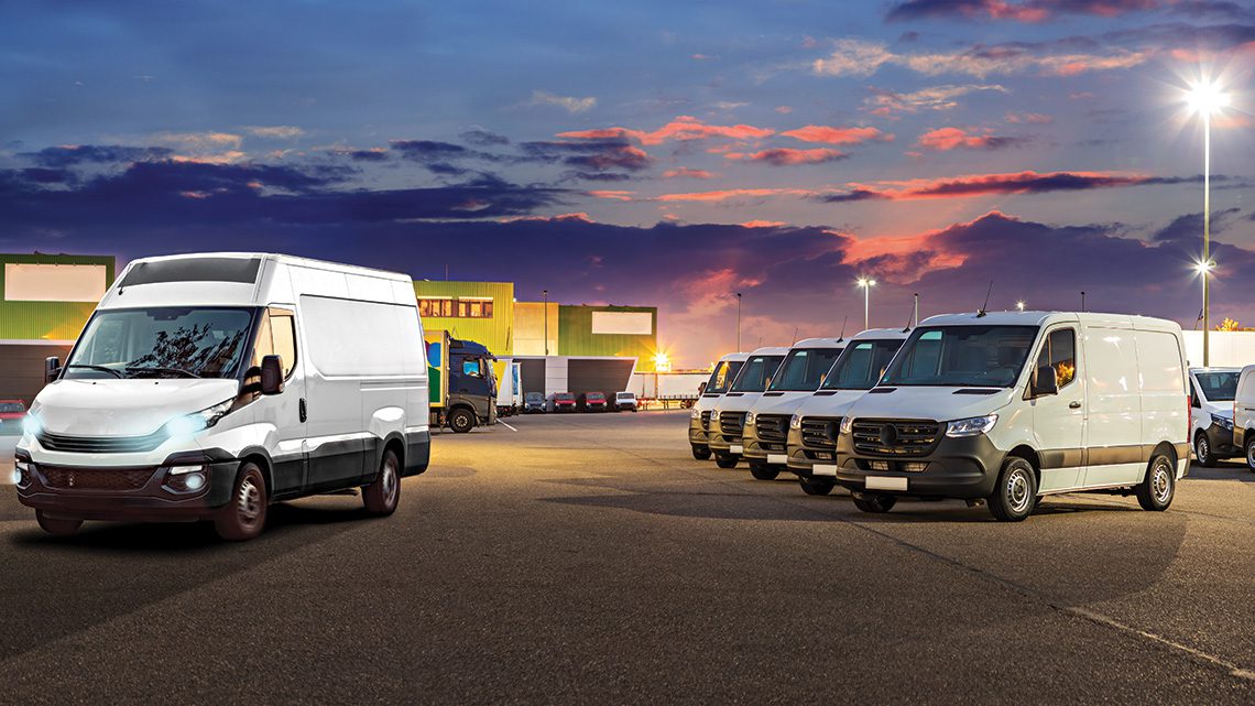Commercial fleet vans in a parking lot at dusk